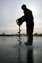 Drilling hole in ice with auger